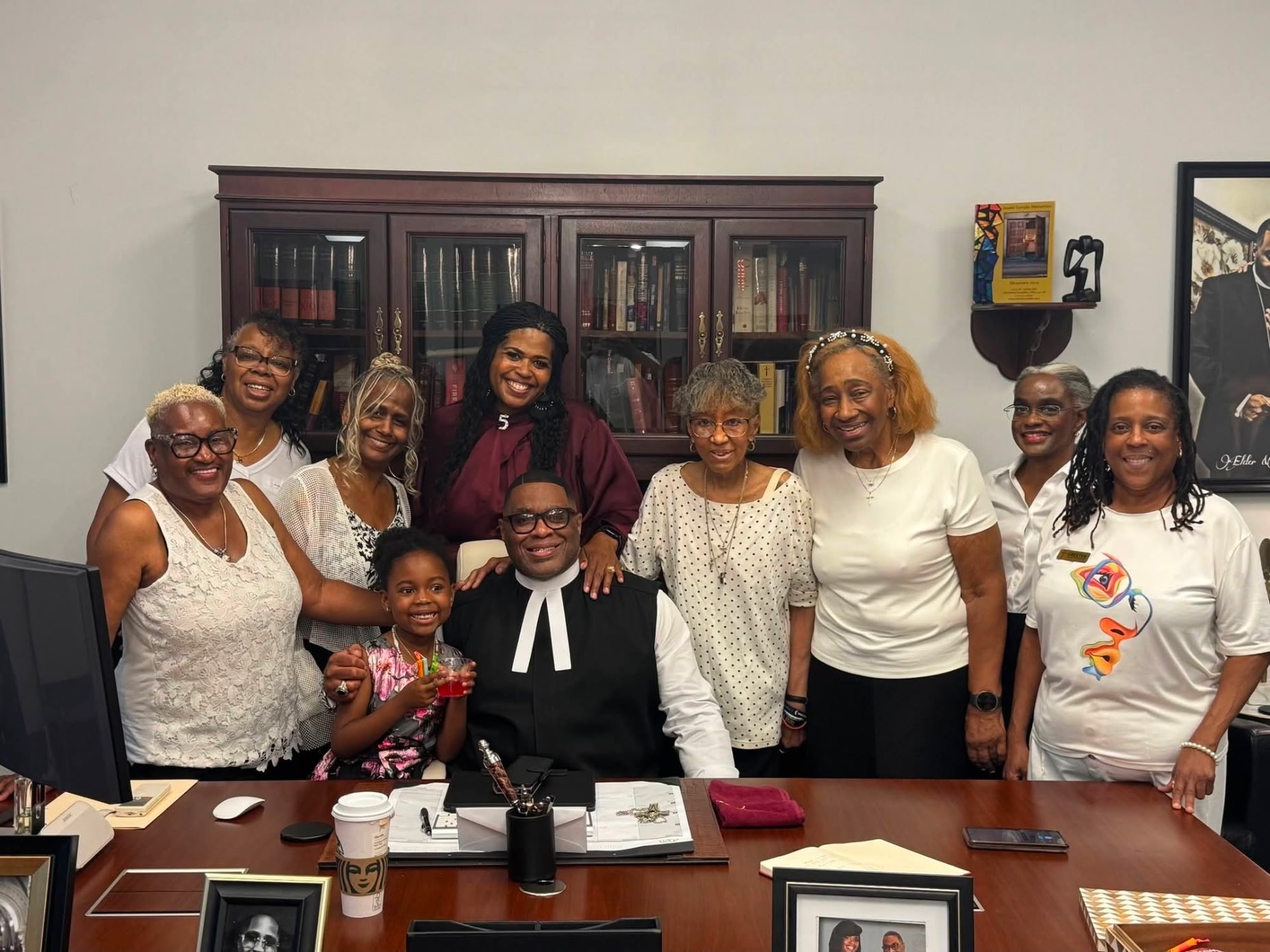 Pastor Sheppard with church members and family in the study