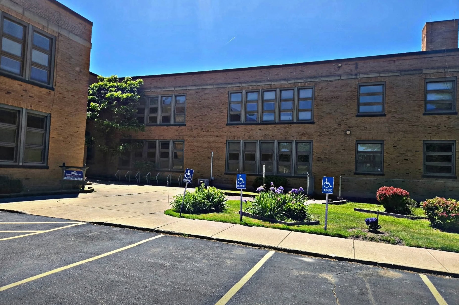 Side courtyard entrance with accessible parking spaces near the building